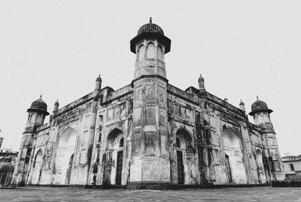 Black and white photo of an old mosque with intricate architecture.